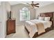 A well-lit bedroom with a ceiling fan and large window at 1255 Hidden Creek Pt, Cumming, GA 30040