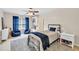 A well-lit bedroom with a ceiling fan and blue accents at 1255 Hidden Creek Pt, Cumming, GA 30040