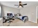 A comfortable bedroom offers a desk area and a ceiling fan at 1255 Hidden Creek Pt, Cumming, GA 30040