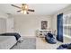 Cozy bedroom featuring a ceiling fan, beanbag chair, and shelving unit for a comfortable, relaxing space at 1255 Hidden Creek Pt, Cumming, GA 30040