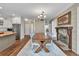 Inviting dining area features a fireplace, hardwood floors, island and views of kitchen at 1255 Hidden Creek Pt, Cumming, GA 30040