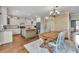 Spacious kitchen with an island, modern appliances, hardwood floors, and adjacent dining area at 1255 Hidden Creek Pt, Cumming, GA 30040