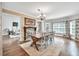 Open dining room with a farmhouse style table, decorative chandelier, and view into living room at 1255 Hidden Creek Pt, Cumming, GA 30040