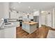 Bright eat-in kitchen featuring stainless appliances, center island with butcher block, and white cabinetry at 1255 Hidden Creek Pt, Cumming, GA 30040