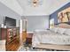 A spacious main bedroom features a tray ceiling, wood floors, and a sitting area at 1255 Hidden Creek Pt, Cumming, GA 30040