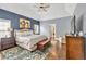 Main bedroom featuring tray ceiling, hardwood flooring, and sitting area at 1255 Hidden Creek Pt, Cumming, GA 30040