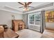 Home office with a large window for natural light, a stylish writing desk, and hardwood floors for a professional setting at 1255 Hidden Creek Pt, Cumming, GA 30040