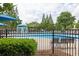 Community pool with clear blue water, seating, and a splash fountain for summer fun at 1255 Hidden Creek Pt, Cumming, GA 30040