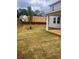 The backyard has newly laid sod and construction on the adjacent property at 1730 Fulmont Cir, Mableton, GA 30126