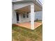 The backyard covered patio has a gray painted surface, columns, and exterior lighting at 1730 Fulmont Cir, Mableton, GA 30126