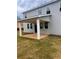 The backyard has a covered patio with large columns, green grass, and gray siding at 1730 Fulmont Cir, Mableton, GA 30126