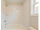 Bright white bathroom featuring a shower over tub, neutral paint, and window at 1730 Fulmont Cir, Mableton, GA 30126