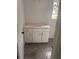 Bathroom vanity featuring white cabinets, stone countertop and hexagonal floor tile at 1730 Fulmont Cir, Mableton, GA 30126