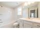 Bathroom with tub, commode, vanity with stone top, and large framed mirror at 1730 Fulmont Cir, Mableton, GA 30126