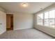 Bedroom with plush carpeting, neutral paint, and a large window providing natural light at 1730 Fulmont Cir, Mableton, GA 30126