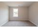 Bedroom featuring neutral walls, gray carpet, window, and visible outlets at 1730 Fulmont Cir, Mableton, GA 30126