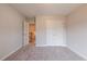 Bedroom featuring neutral walls, gray carpet, closet, and open doorway at 1730 Fulmont Cir, Mableton, GA 30126