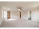 Spacious bedroom featuring plush carpeting and a ceiling fan with doors leading to other rooms at 1730 Fulmont Cir, Mableton, GA 30126