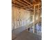 Unfinished interior showcasing a staircase, door, and framed walls, waiting to be transformed into a functional space at 1730 Fulmont Cir, Mableton, GA 30126