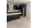 This kitchen features dark cabinetry and an island with an overhanging countertop at 1730 Fulmont Cir, Mableton, GA 30126