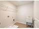 This laundry room features neutral walls, vinyl flooring, sink and overhead storage at 1730 Fulmont Cir, Mableton, GA 30126
