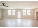 Spacious living room with wood floors, windows, a back door, and a hanging chandelier at 1730 Fulmont Cir, Mableton, GA 30126