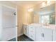 Bathroom showcasing double vanities, sleek fixtures, and access to the shower and primary bedroom at 1730 Fulmont Cir, Mableton, GA 30126