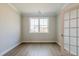 Cozy home office with wood floors, crown molding, bright windows, and a glass paneled door at 1730 Fulmont Cir, Mableton, GA 30126