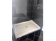 Modern walk-in shower with stylish dark tile, featuring a built-in niche and corner seat at 1730 Fulmont Cir, Mableton, GA 30126
