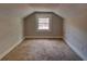 Cozy attic room with carpet, neutral paint, and a bright window at 246 Stafford Nw St, Atlanta, GA 30314