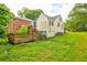 Backyard featuring a wooden deck, steps to grade and overgrown grass at 246 Stafford Nw St, Atlanta, GA 30314