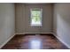 Cozy bedroom featuring hardwood floors, a window, and neutral paint at 246 Stafford Nw St, Atlanta, GA 30314