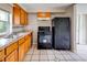 This kitchen features tile flooring, wood cabinets, and a full suite of black appliances at 246 Stafford Nw St, Atlanta, GA 30314