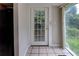 Bright sunroom with tiled floors, view of the outside, and a convenient entry door at 246 Stafford Nw St, Atlanta, GA 30314