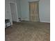 Empty bedroom with neutral-colored carpet, light blue walls, and a small storage closet at 4 Kelso At Peyton Sw Dr, Atlanta, GA 30311