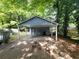 Carport featuring a concrete floor and ample space, partially shaded by surrounding trees at 4 Kelso At Peyton Sw Dr, Atlanta, GA 30311