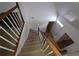 Stairway leading to the upper level with wood railing at 4 Kelso At Peyton Sw Dr, Atlanta, GA 30311