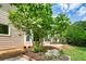 Landscaped backyard with a tree and inviting patio area for outdoor enjoyment at 510 Morning Mist Ct, Alpharetta, GA 30022