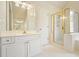 Bathroom featuring white cabinets, a white countertop and glass shower with gold trim at 510 Morning Mist Ct, Alpharetta, GA 30022