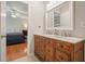 Bathroom with wooden vanity with double sinks, tile floor, and an open bedroom view at 510 Morning Mist Ct, Alpharetta, GA 30022