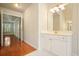 Bathroom with tile flooring, double sink vanity and hardwood flooring leading down hallway at 510 Morning Mist Ct, Alpharetta, GA 30022