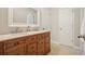 Bathroom featuring double sink vanity with marble countertop and wood cabinets at 510 Morning Mist Ct, Alpharetta, GA 30022