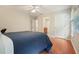 Cozy bedroom featuring hardwood floors, ceiling fan, and neutral paint at 510 Morning Mist Ct, Alpharetta, GA 30022