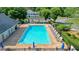 Large community pool with plenty of lounge chairs, umbrellas, and a covered seating area at 510 Morning Mist Ct, Alpharetta, GA 30022