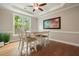 Dining room with wood floors, large window, and a decorative painting on the wall at 510 Morning Mist Ct, Alpharetta, GA 30022