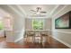 Elegant dining room features a tray ceiling, hardwood floors, a large window, and stylish decor at 510 Morning Mist Ct, Alpharetta, GA 30022