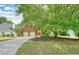 Beautiful two-story brick home with a large front yard featuring mature trees and landscaping at 510 Morning Mist Ct, Alpharetta, GA 30022