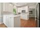 Bright kitchen with white cabinets, granite countertops, stainless steel appliances, and hardwood floors at 510 Morning Mist Ct, Alpharetta, GA 30022