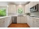 Modern kitchen showcasing white cabinets, stainless steel appliances, and a bright window at 510 Morning Mist Ct, Alpharetta, GA 30022