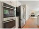 Kitchen featuring stainless steel appliances, with an oven and refrigerator next to view of the living room at 510 Morning Mist Ct, Alpharetta, GA 30022